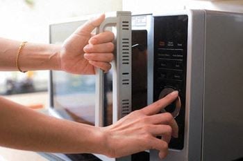 Person opening a microwave